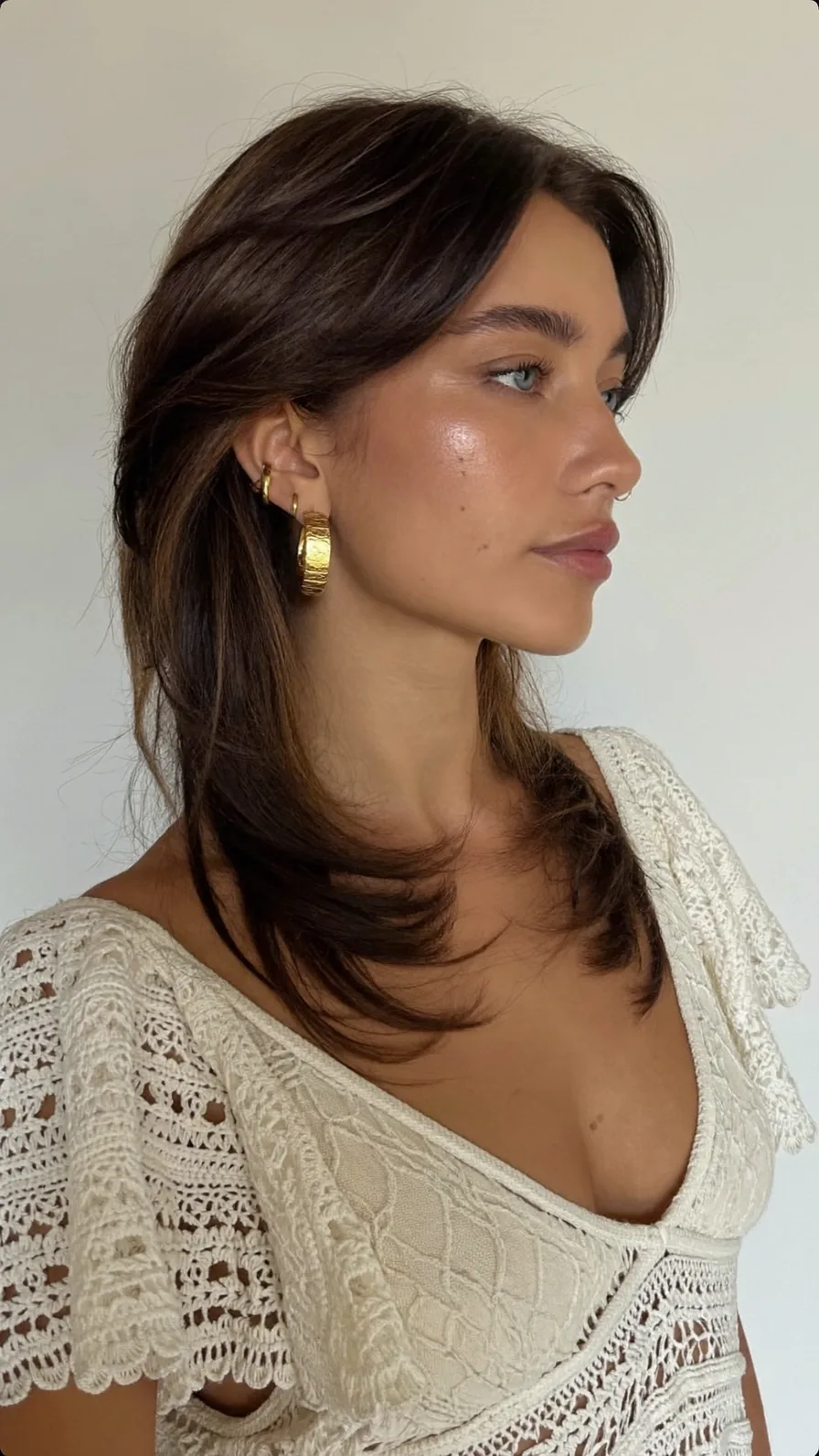 Shoulder-Length Feathered Layers with Curtain Bangs