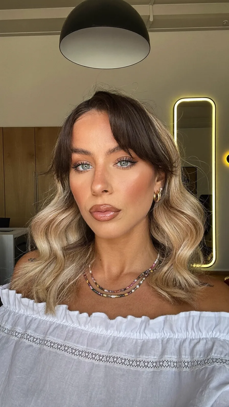 Modern Shoulder-Length Lob with Ash Blonde Balayage and Curtain Bangs