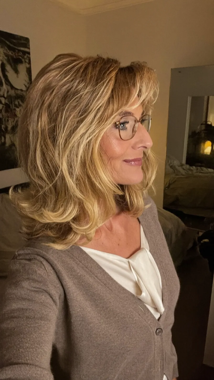 Voluminous Shoulder-Length Layered Blowout with Side-Swept Bangs