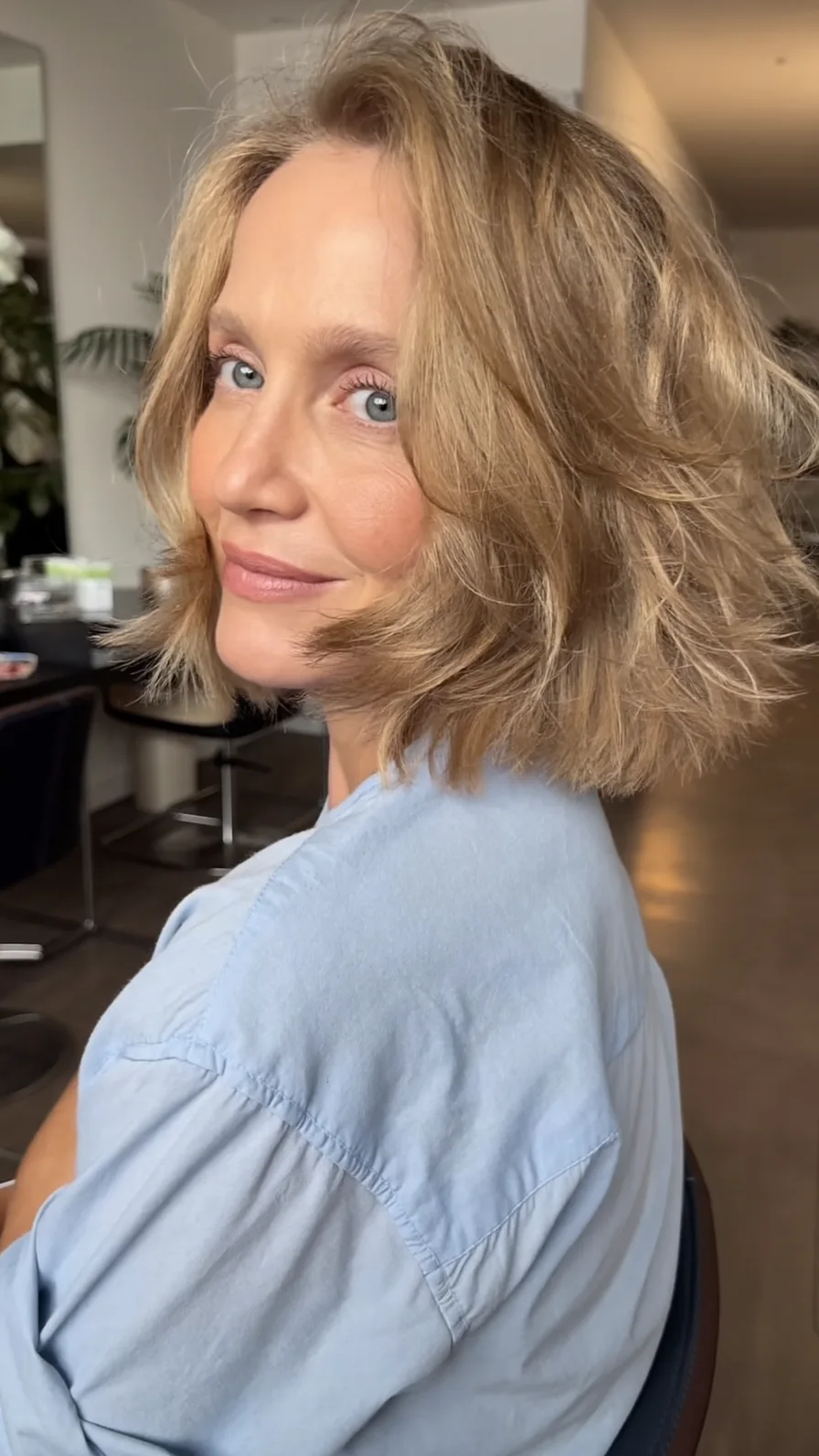Layered Shoulder-Length Feathered Hairstyle with Side Bangs