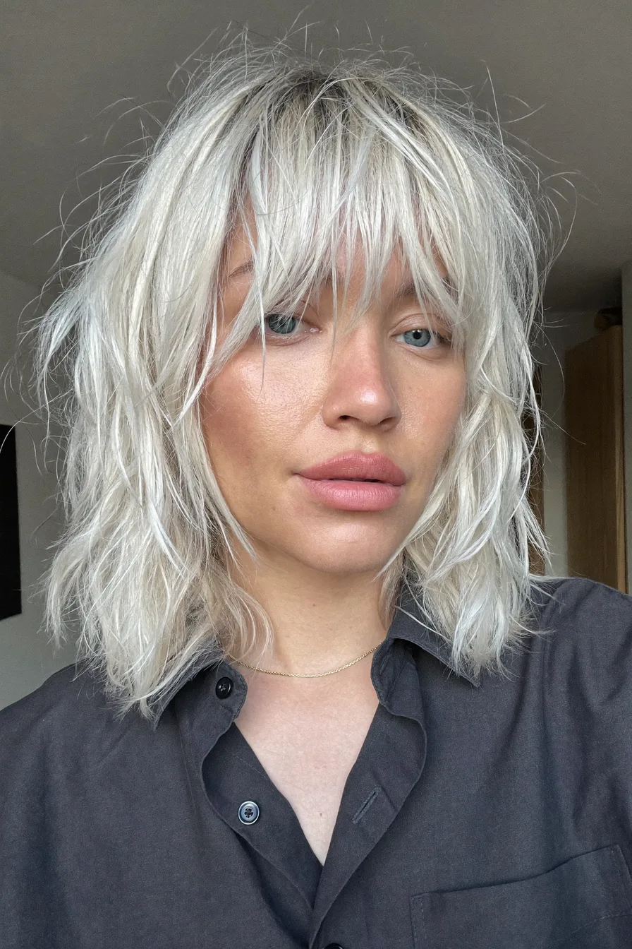 Textured Shoulder-Length Shag with Wispy Platinum Blonde Bangs
