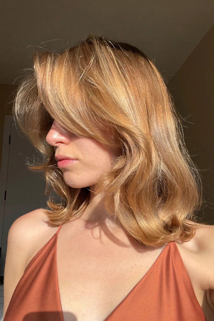 Soft Waves with Sun-Kissed Layers and Side-Swept Bangs Style