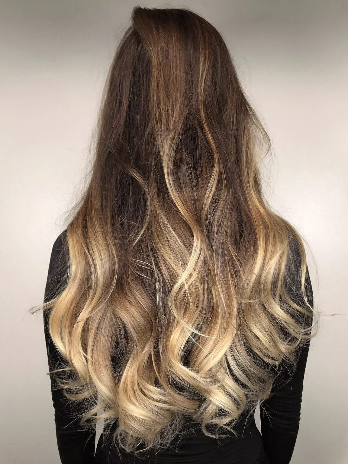 Voluminous Wavy Layers in Honey Blonde Balayage