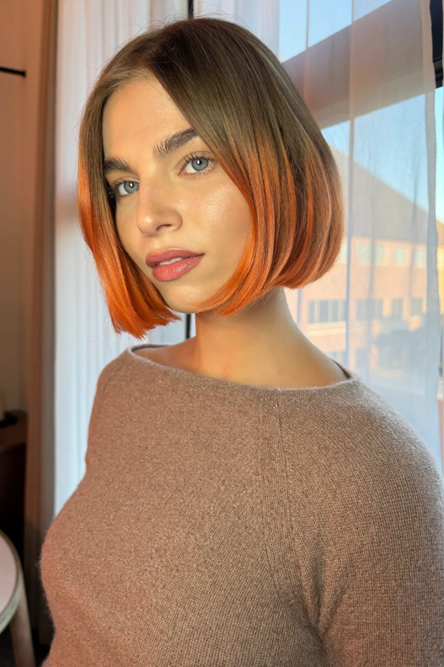 Sleek Center-Parted Straight Bob With Bold Orange Tips