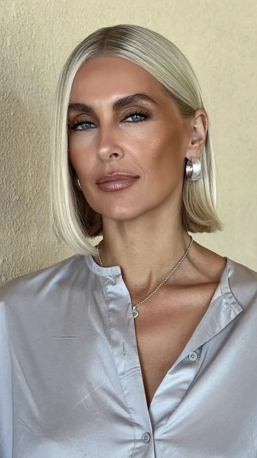 Sleek Platinum Blonde Center-Parted Classic Chin-Length Bob