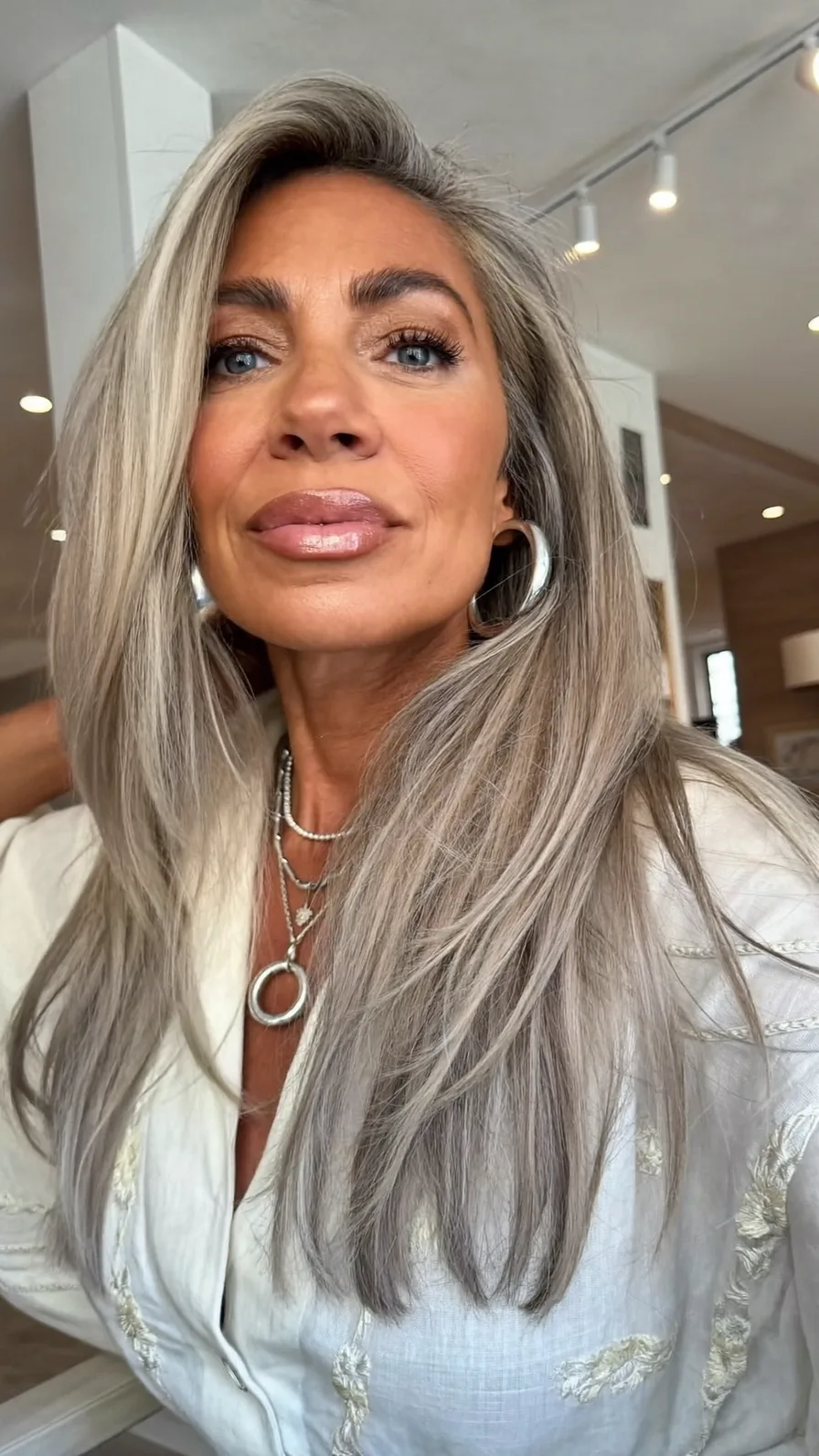 Elegant Long Layers with Deep Side Part and Cool Ash Blonde Shine