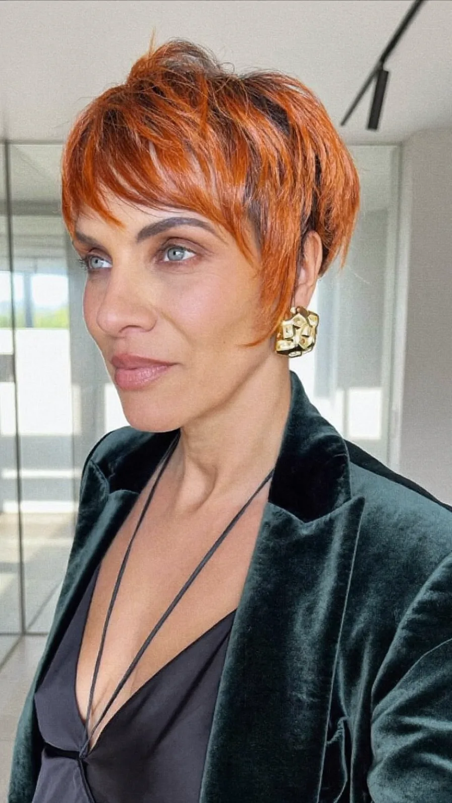 Modern Textured Copper Red Pixie Cut with Side-Swept Bangs