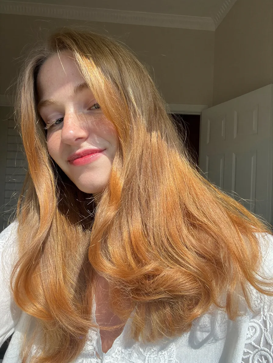 Medium Layered Warm Strawberry Blonde with Curtain Bangs