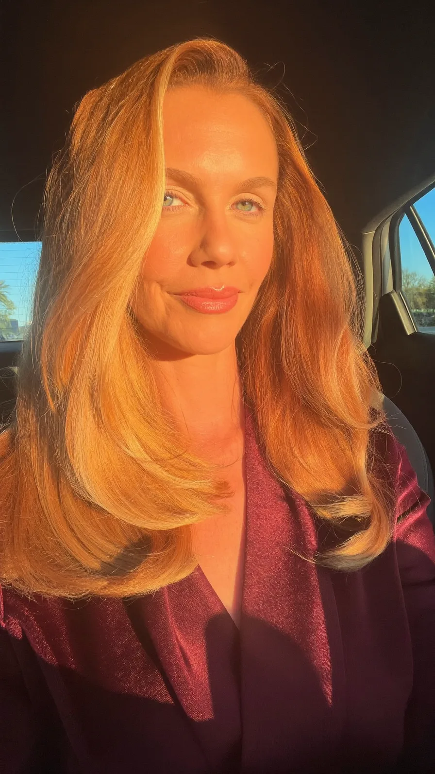 Voluminous golden strawberry blonde layered medium hairstyle