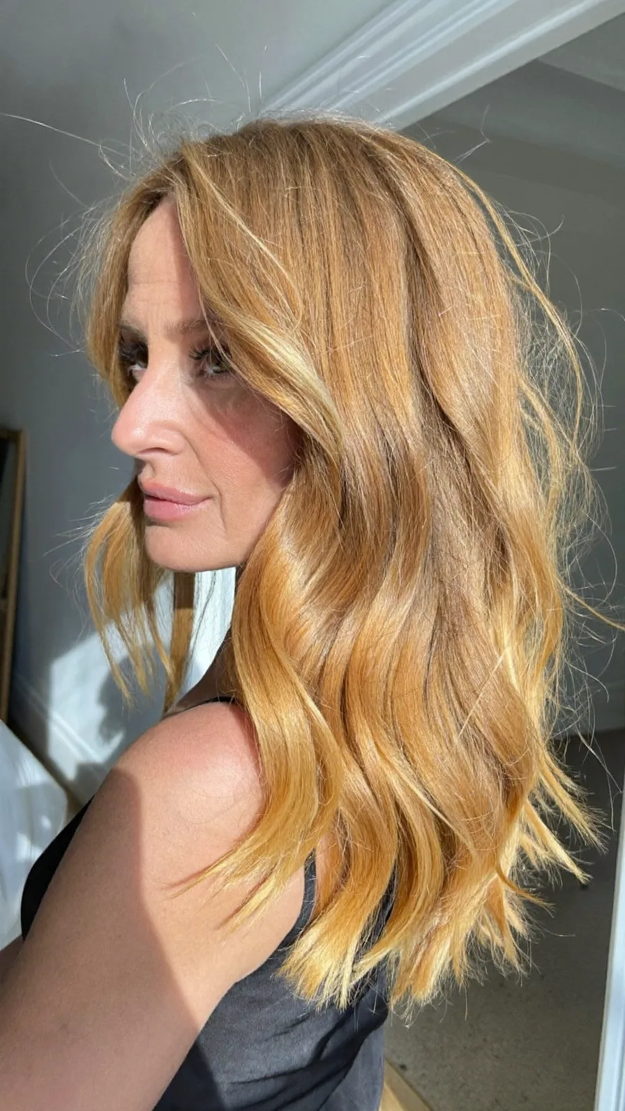 Sun-Kissed Medium Length Wavy Hair with Side-Swept Layers