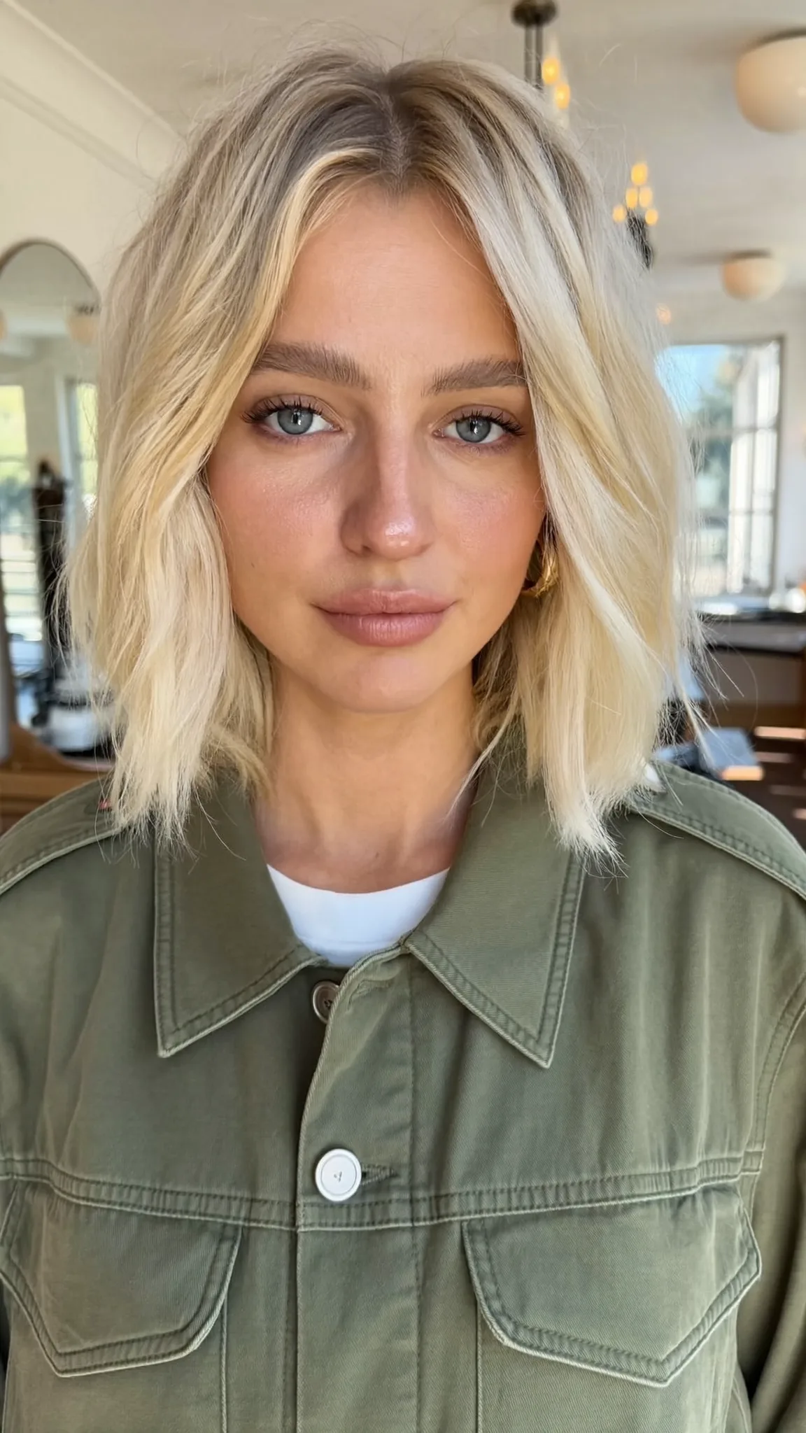 Chin-Length Platinum Ash Blonde Bob with Wavy Texture and Curtain Bangs