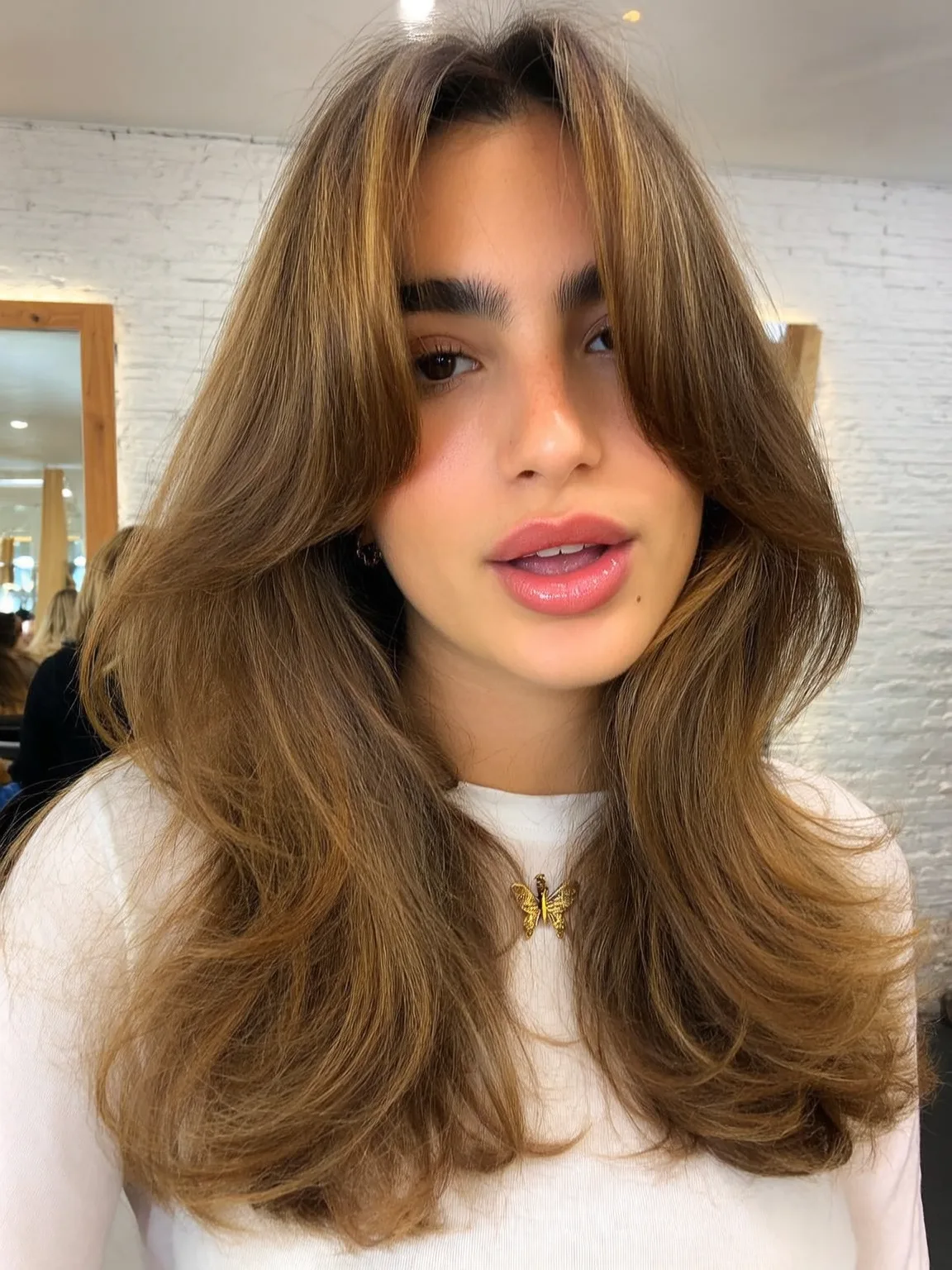 Warm Caramel Brown Wavy Layers with Curtain Bangs