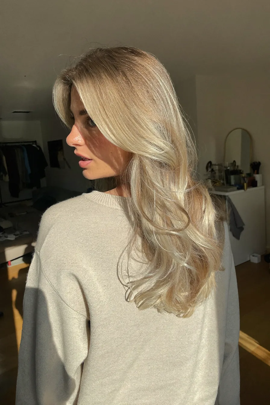 Voluminous Layered Ash Blonde Shoulder-Length Hair with Subtle Waves