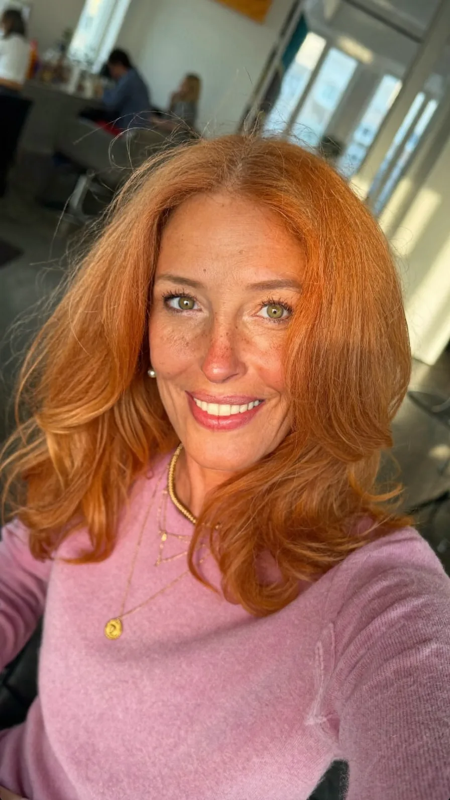 Voluminous Copper Red Long Layered Hairstyle with Feathered Ends