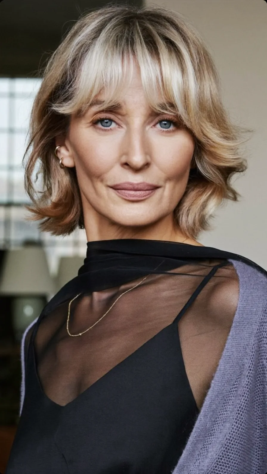 Ash Blonde Wavy Chin-Length Hair with Feathered Curtain Bangs