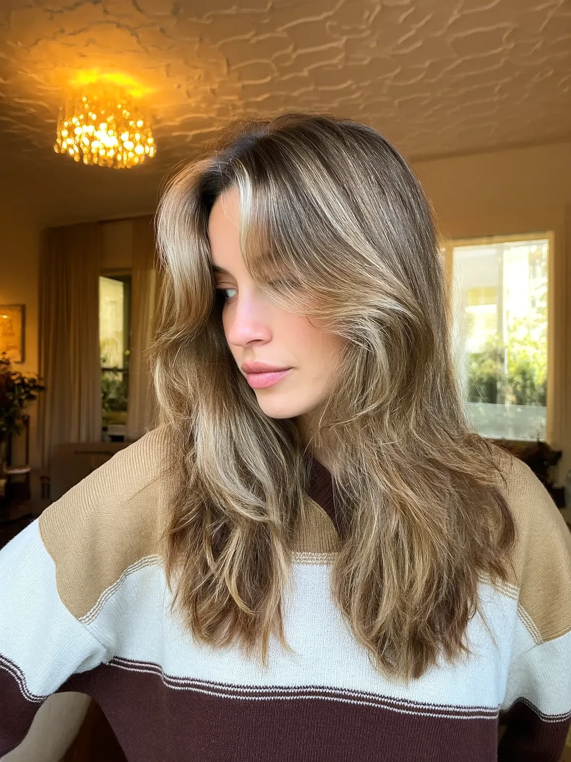Honey Blonde Balayage Layers with Voluminous Curtain Bangs