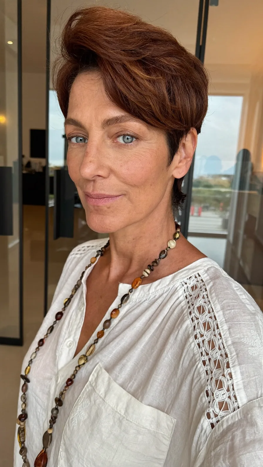 Voluminous Layered Short Pixie with Side-Swept Auburn Highlights