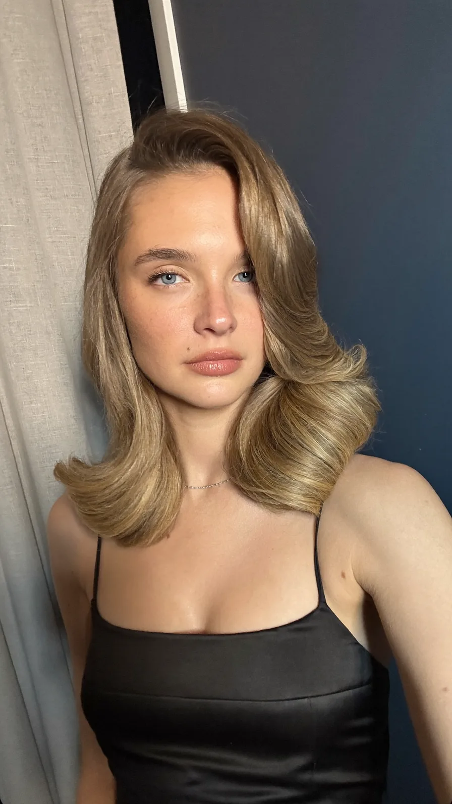 Soft voluminous shoulder-length honey blonde layered blowout