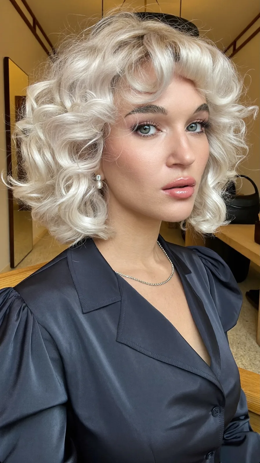 Platinum Blonde Curly Bob with Voluminous Curtain Bangs