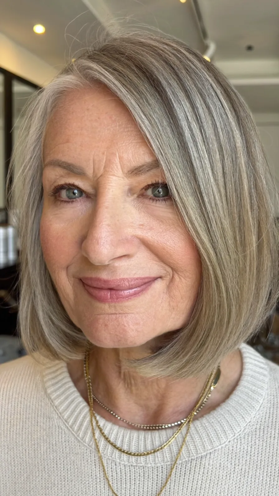 Elegant Cool Ash Blonde Rounded Bob with Side-Swept Bangs