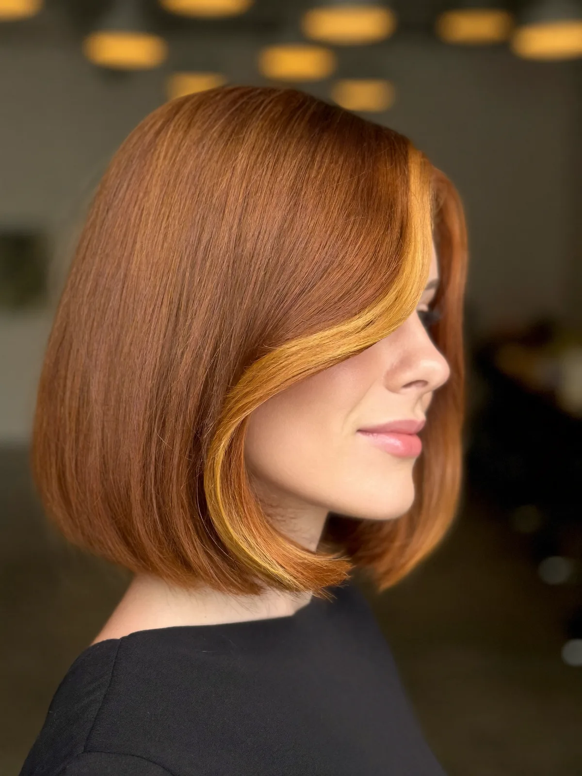 Copper Blunt Bob with Golden Face-Framing Highlights and Sleek Finish