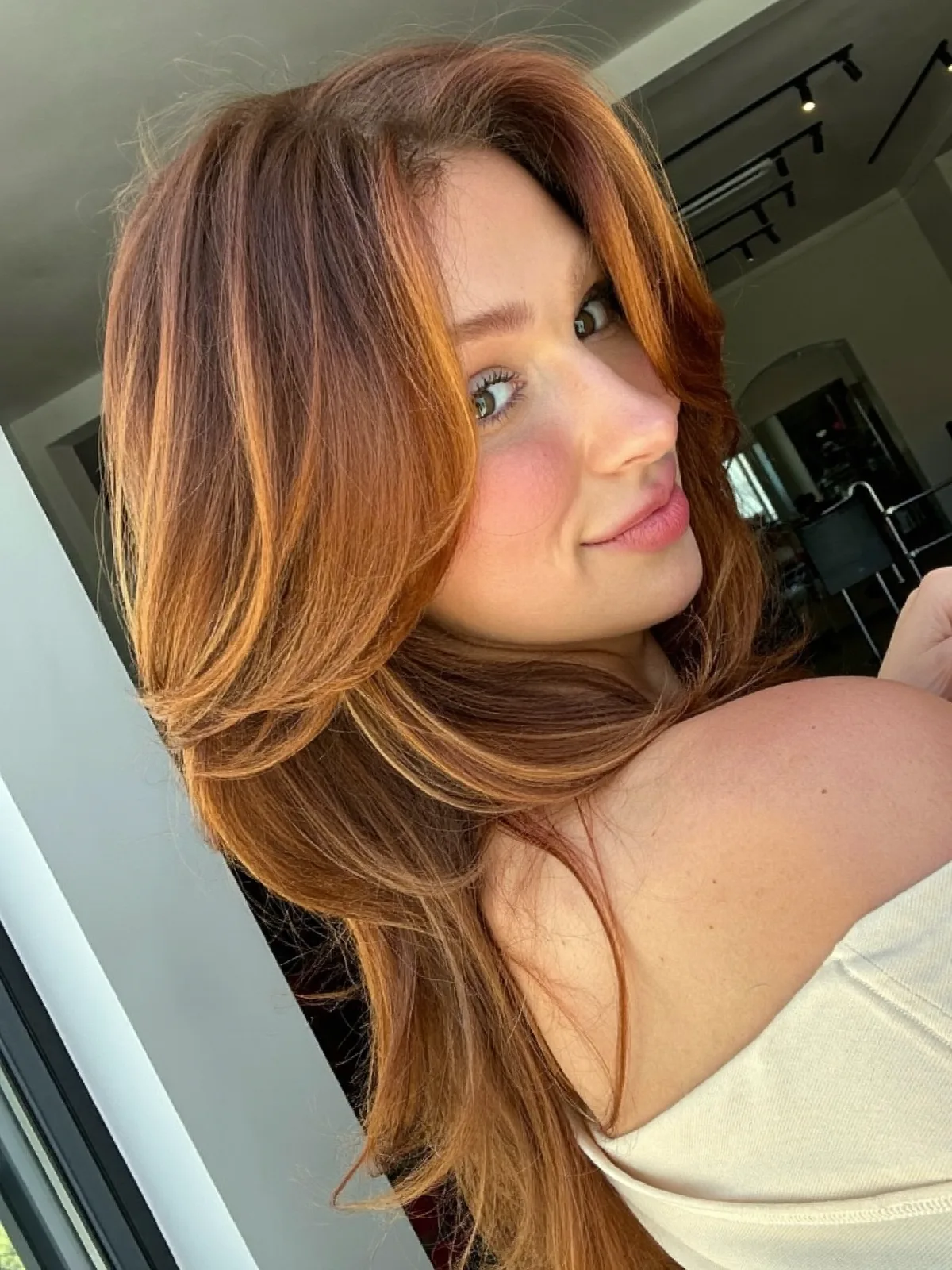 Layered Blowout with Face-Framing Warm Caramel Brown Highlights