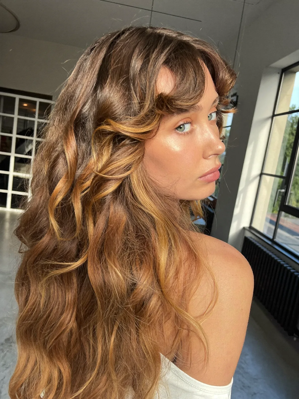 Soft Waves with Warm Caramel Brown Balayage and Face-Framing Layers
