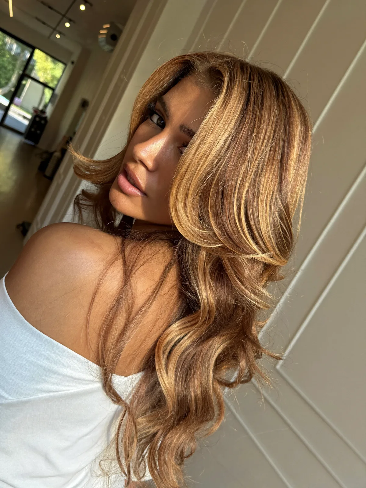 Voluminous Layered Waves With Warm Caramel Brown Highlights