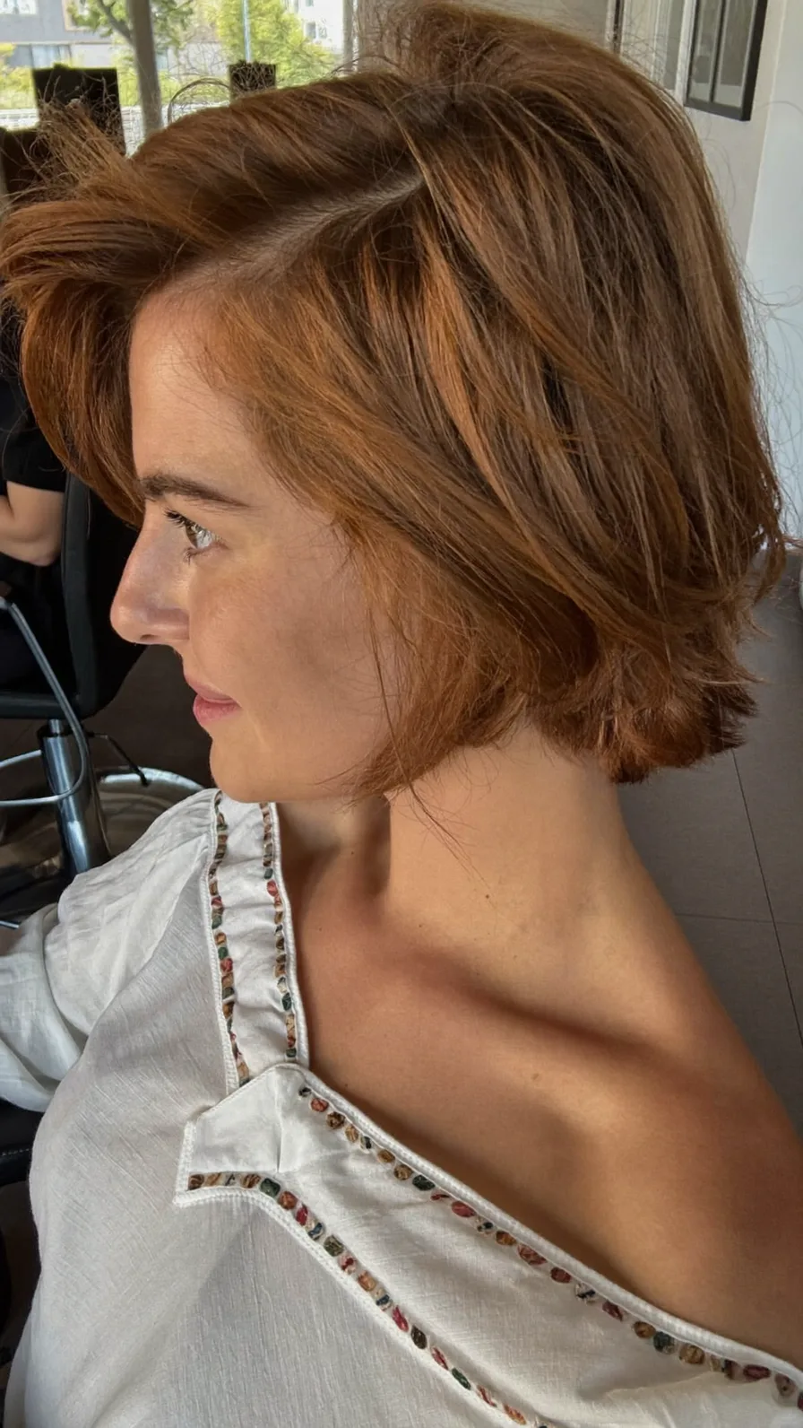 Chin-Length Textured Bob with Warm Copper Tone and Side Bangs
