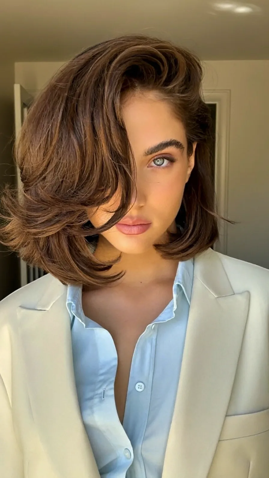Voluminous Warm Chestnut Brown Layered Bob Hairstyle