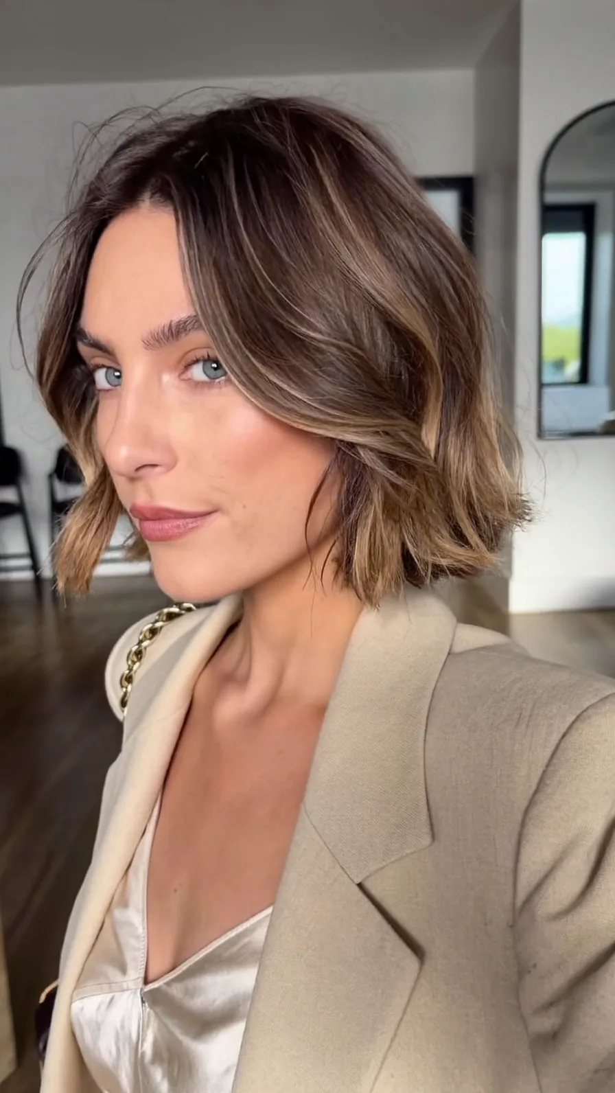Chic Textured Chin-Length Bob with Curtain Bangs and Balayage