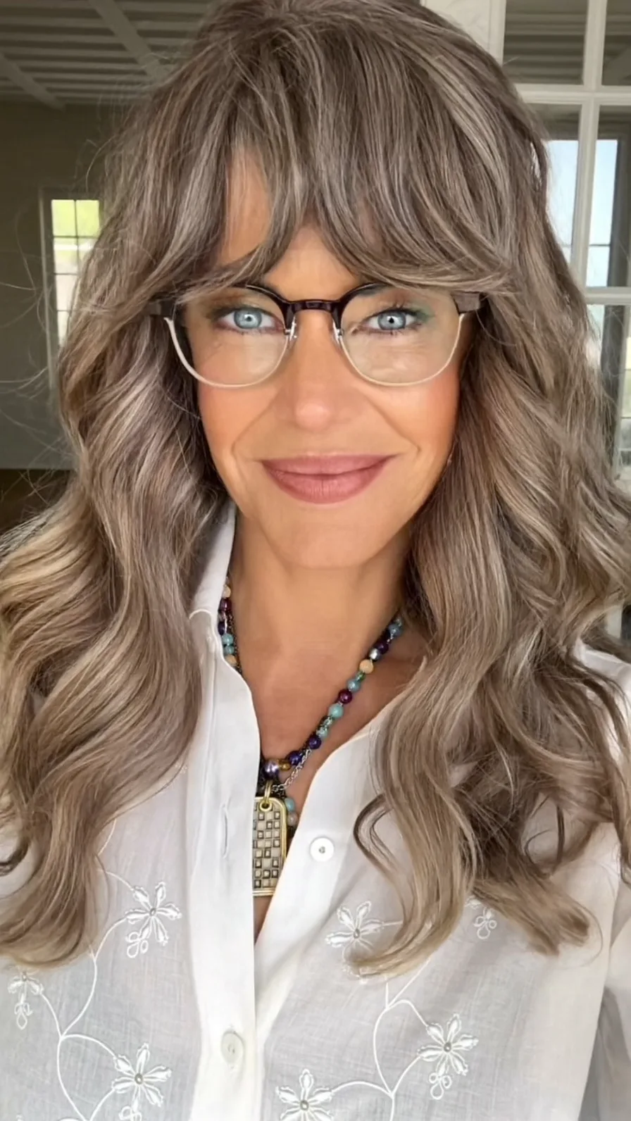 Long Layered Wavy Hair with Soft Feathered Curtain Bangs