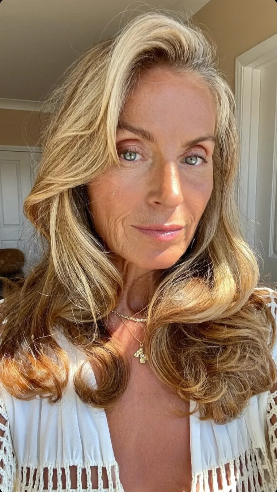 Voluminous Honey Blonde Long Layered Waves with Side Swept Bangs