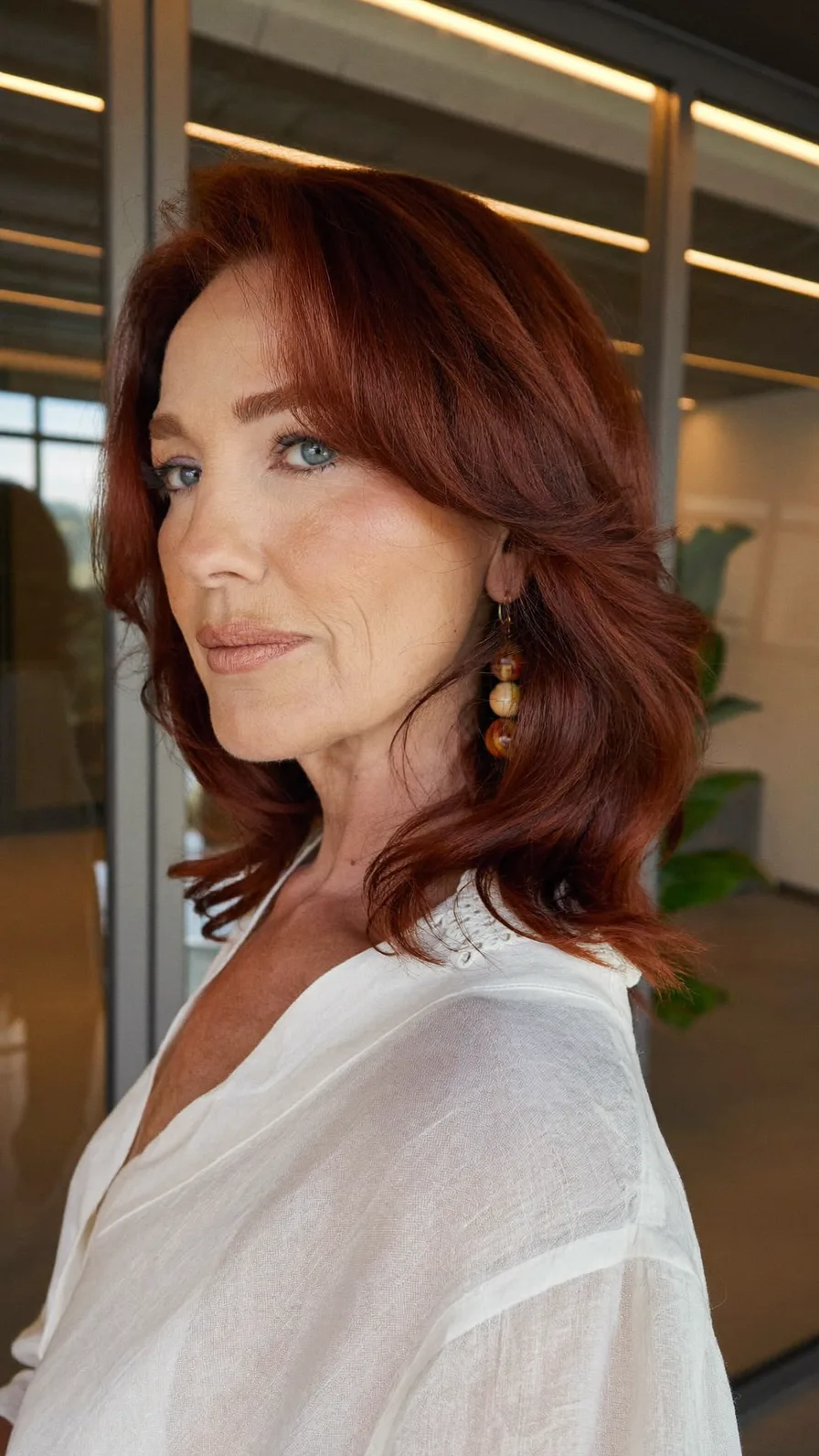 Rich Auburn Shoulder-Length Hair with Soft Curtain Bangs