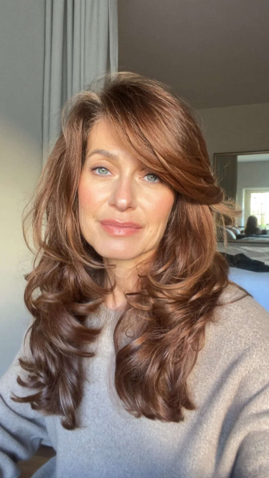 Voluminous Layered Long Hair with Soft Side-Swept Curls