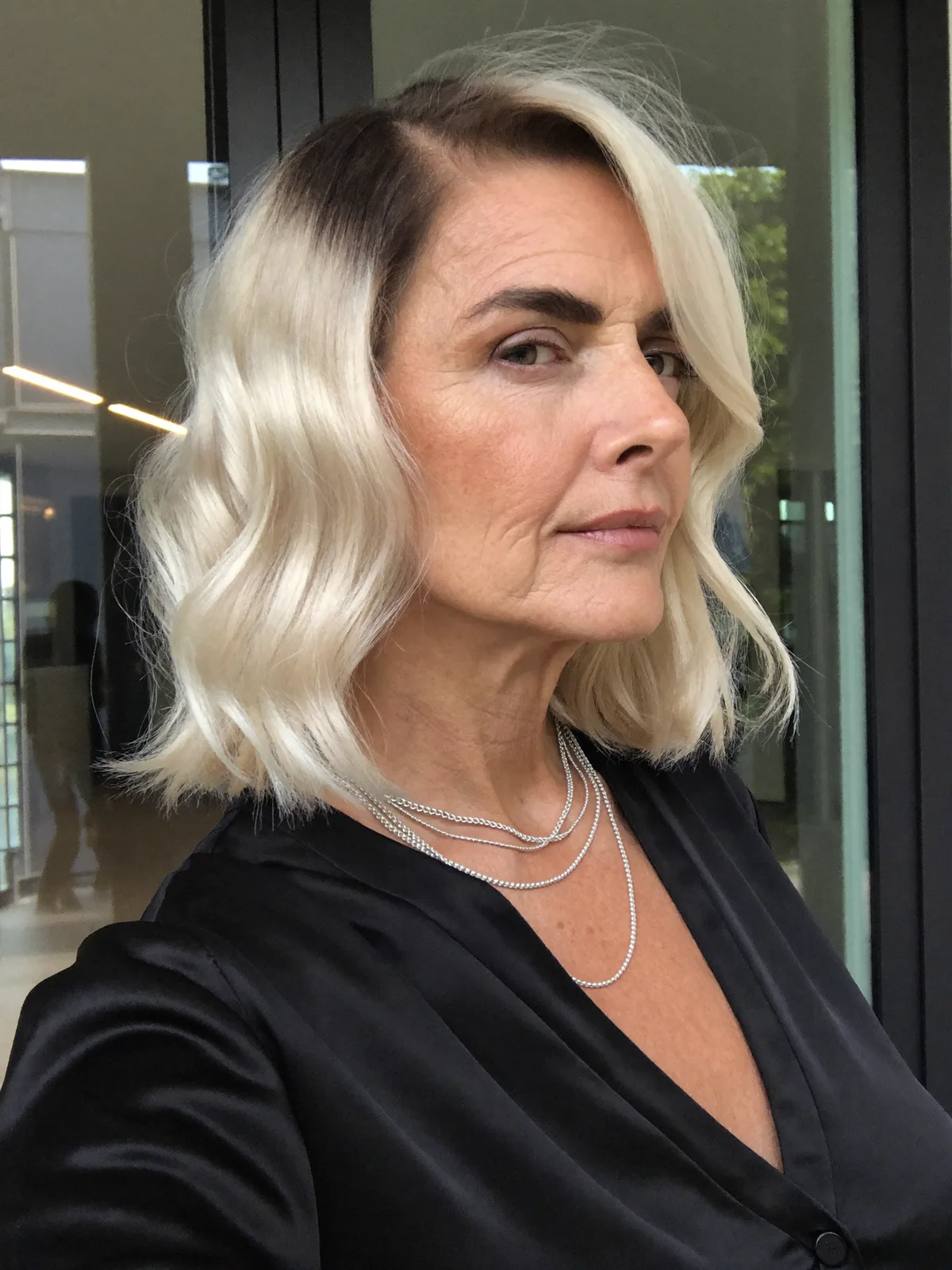 Soft Silver Blonde Waves with Deep Side Part for Mature Women