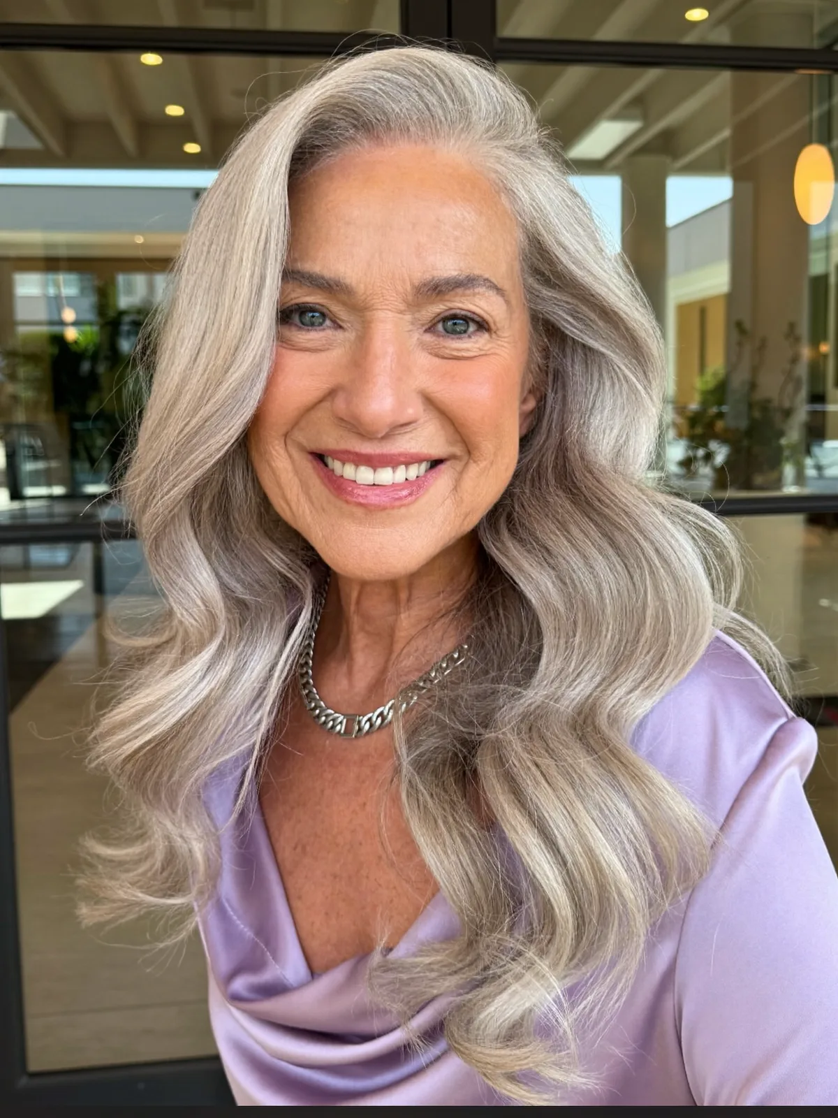 Elegant Silver Waves with Soft Face-Framing Layers for Mature Hair