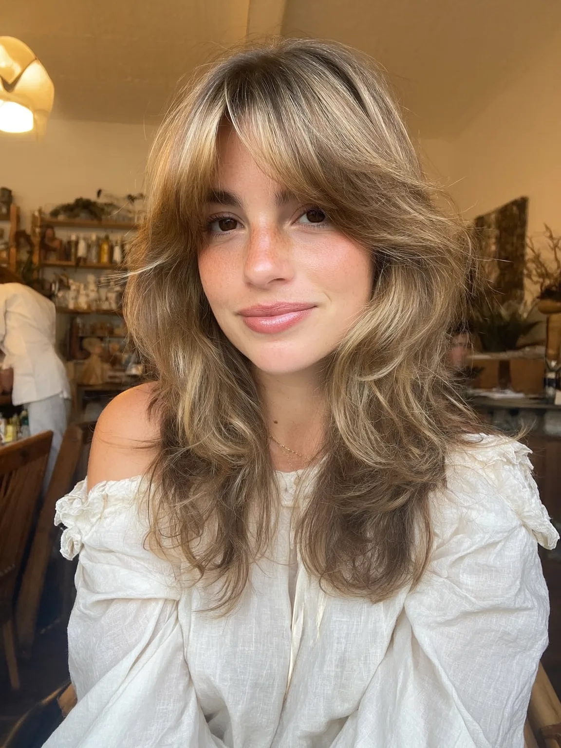 Long Sandy Blonde Waves with Curtain Bangs