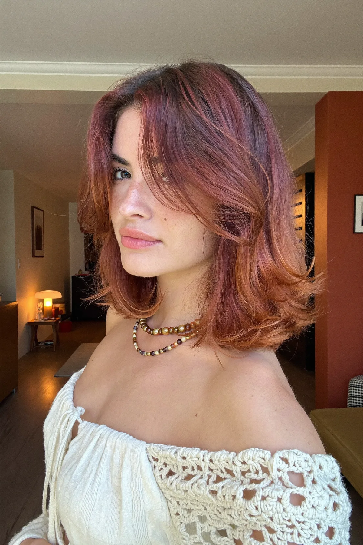 Wavy Strawberry Blonde Lob with Curtain Bangs for Effortless Chic