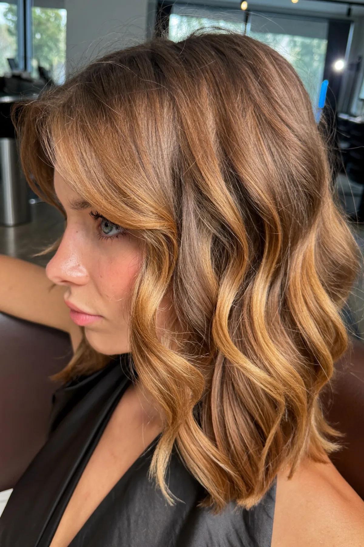 Caramel Bronde Balayage Long Bob With Curtain Bangs and Waves