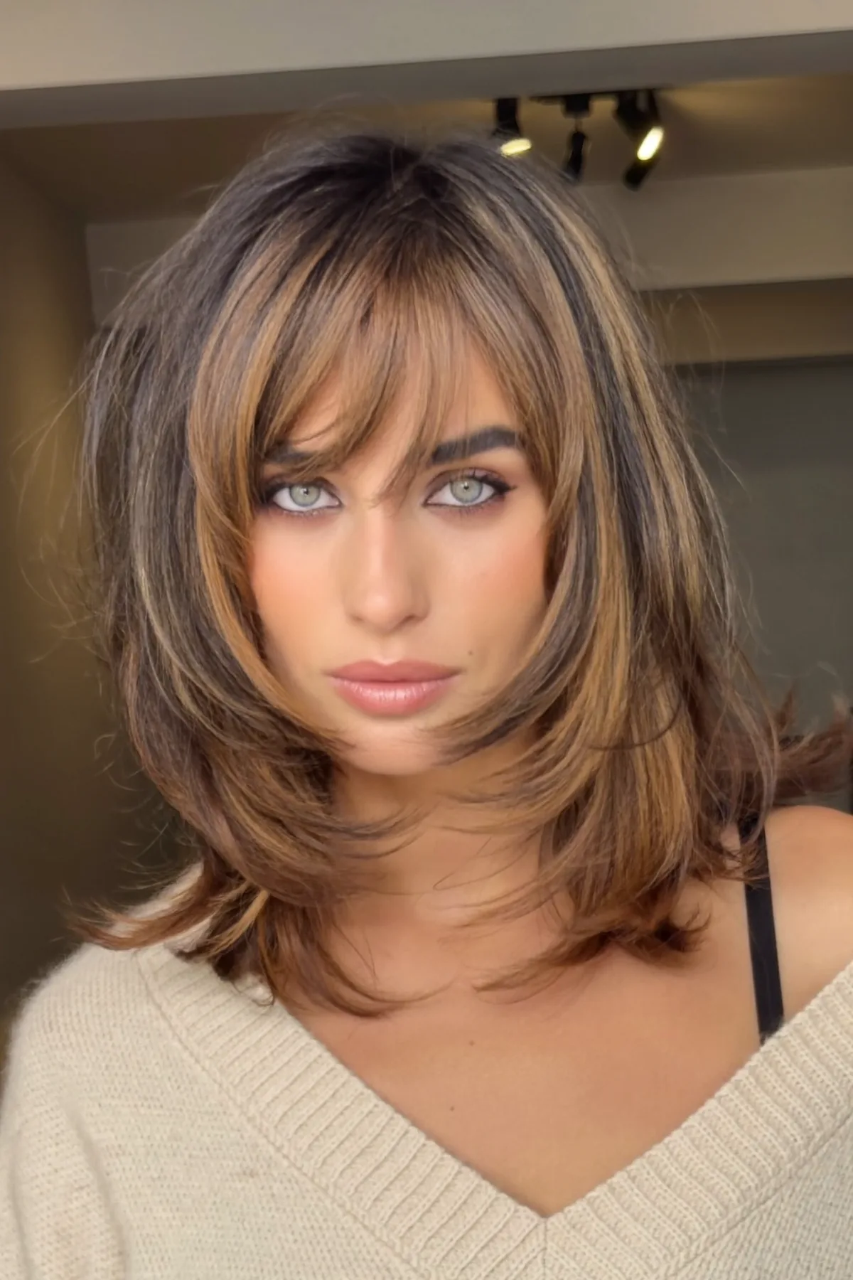 Caramel Bronde Balayage Lob with Wavy Texture and Curtain Bangs