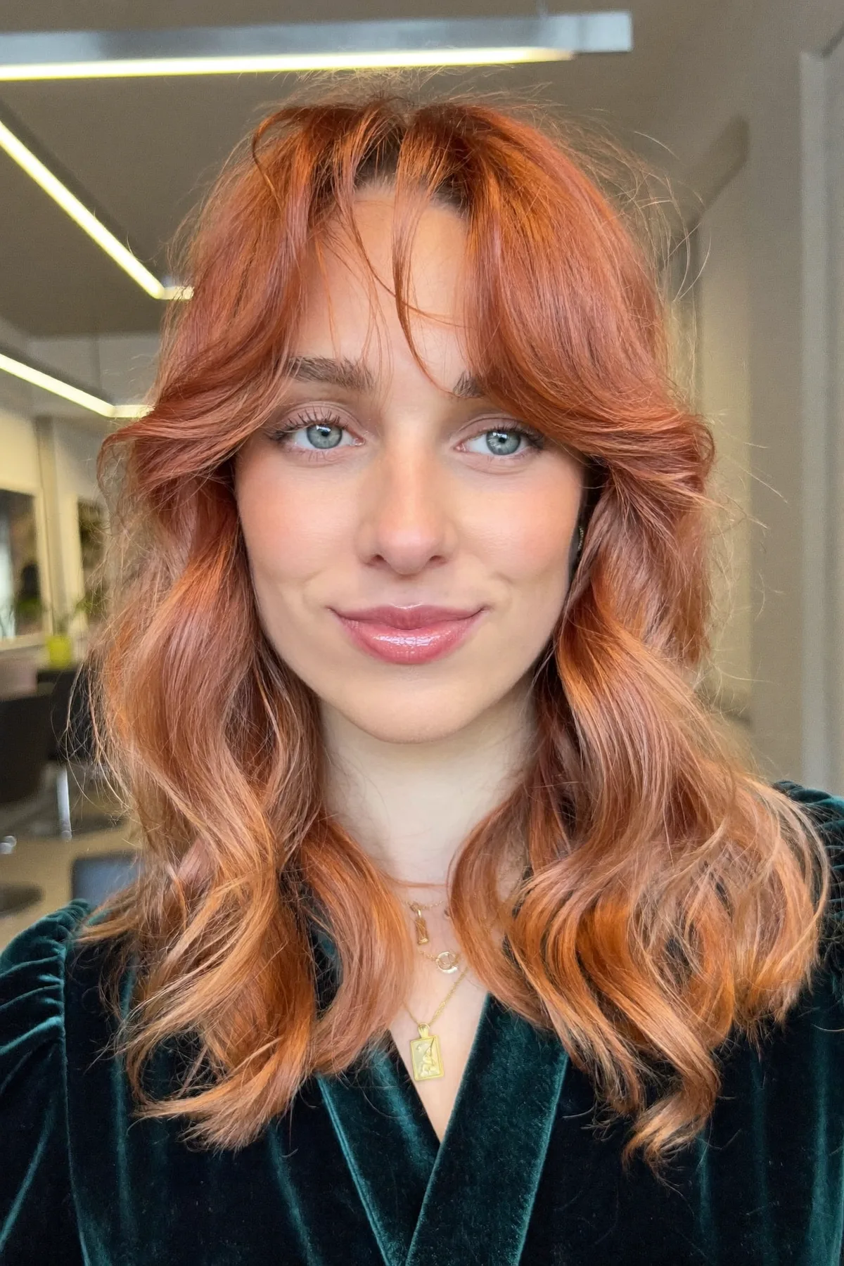 Glossy Strawberry Blonde Lob with Wavy Texture and Curtain Bangs