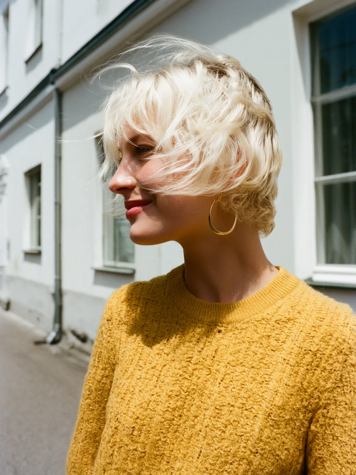 Voluminous Vanilla Blonde Wavy Pixie with Wispy Bangs
