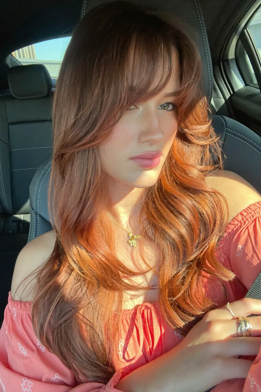 Sunlit Copper Layers with Side-Swept Wispy Bangs Perfection