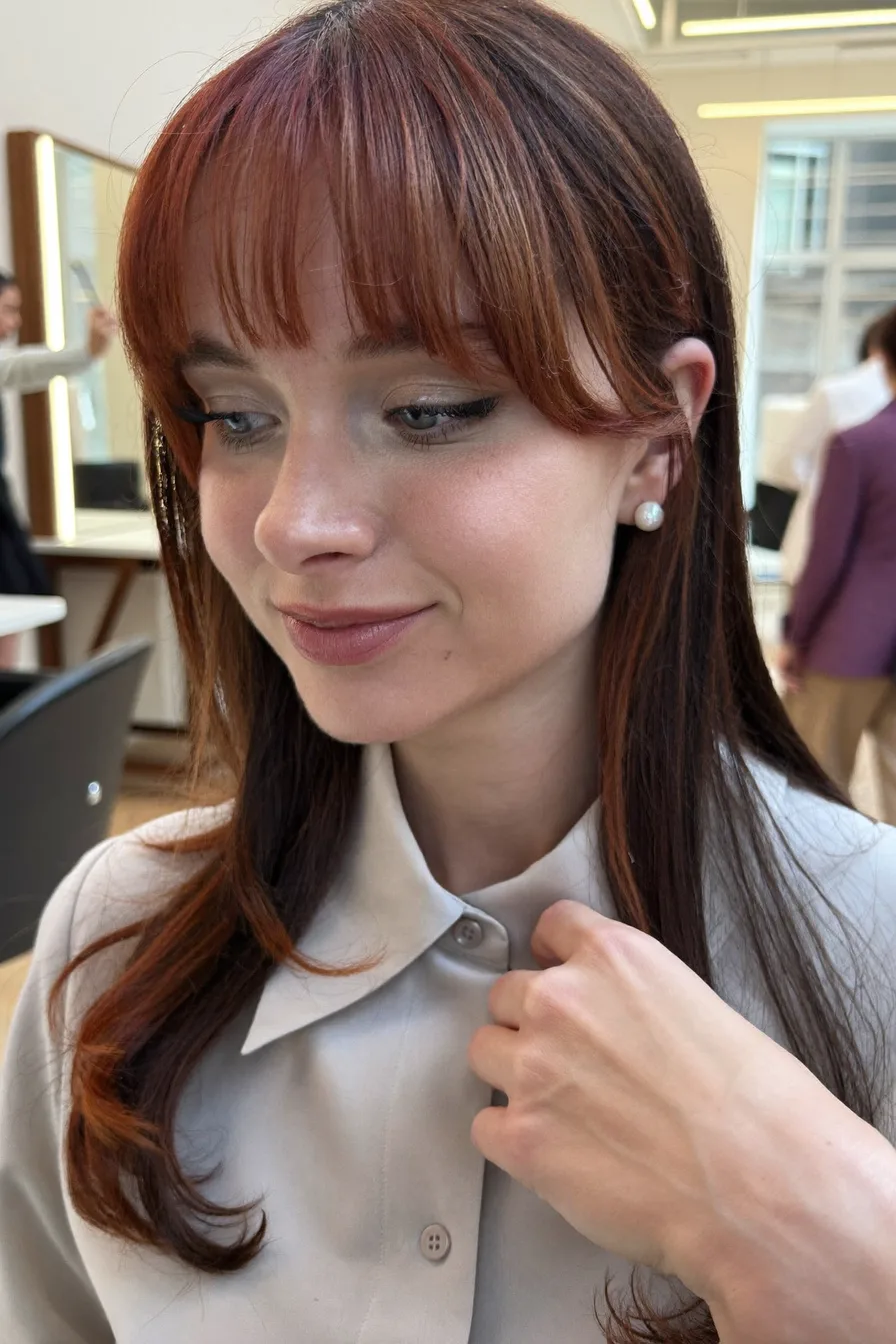 Long Layered Tresses with Face-Framing Wispy Bangs